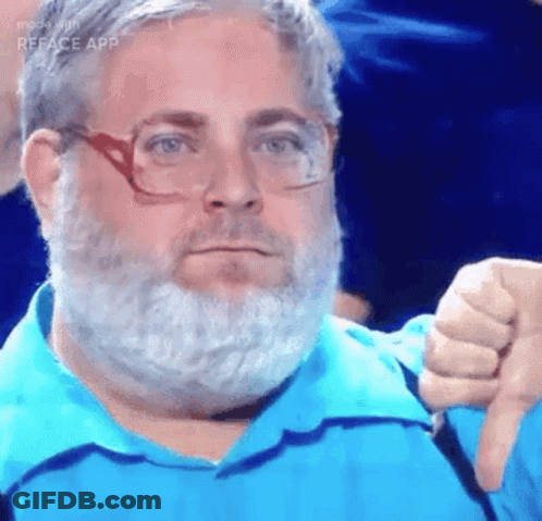 A Man With A Beard And Glasses Is Wearing A Blue Shirt And Giving A Thumbs Down Sign . GIF