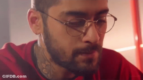 A Man With A Beard And Glasses Is Wearing A Red Shirt And A Red Shirt . GIF