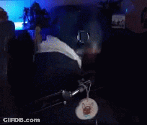 A Man With A Beard And Glasses Is Wearing Headphones And A Hat GIF