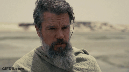 A Man With A Beard And Gray Hair Is Wrapped In A Cloth GIF