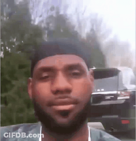 A Man With A Beard And Hat Is Making A Funny Face . GIF