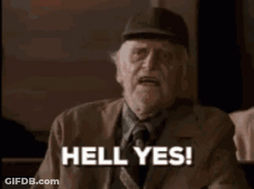 A Man With A Beard And Hat Is Making A Funny Face And Saying `` Hell Yes ! '' GIF