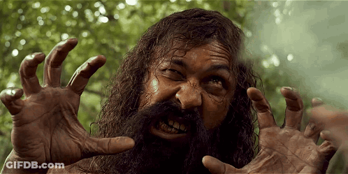 A Man With A Beard And Long Hair Is Making A Funny Face GIF