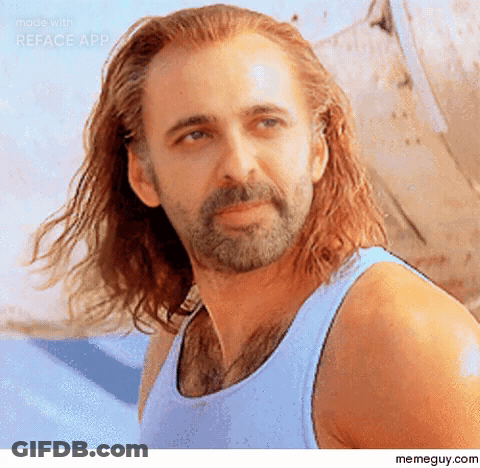 A Man With A Beard And Long Hair Is Wearing A Blue Tank Top . GIF