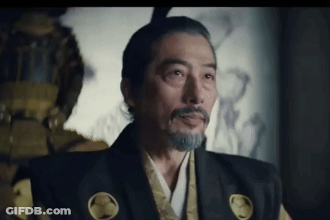 A Man With A Beard And Mohawk Is Wearing A Samurai Costume And Looking At The Camera . GIF