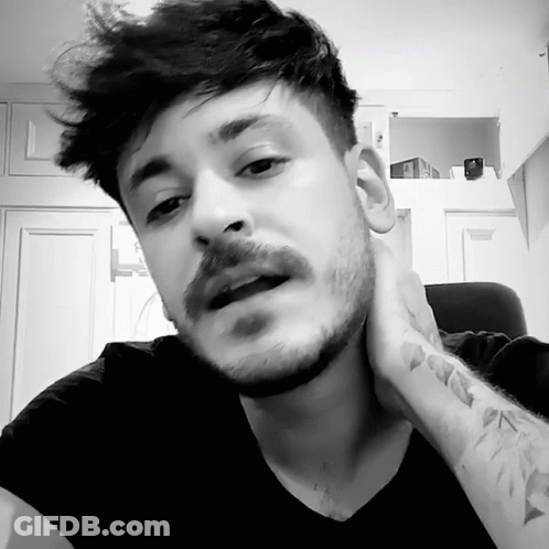 A Man With A Beard And Mustache Has A Tattoo On His Wrist GIF