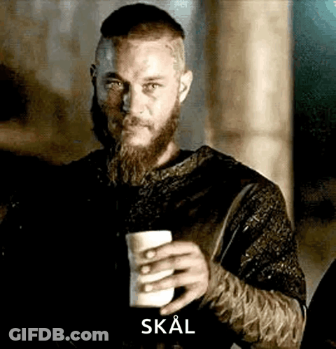 A Man With A Beard And Mustache Is Holding A Cup Of Coffee . GIF