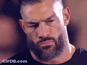 A Man With A Beard And Mustache Is Making A Funny Face . GIF