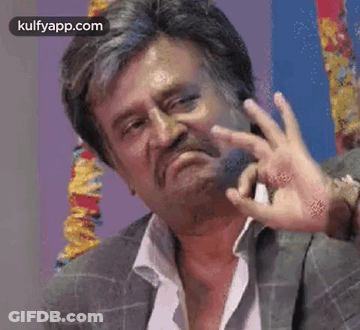 A Man With A Beard And Mustache Is Making A Funny Face With His Hands . GIF