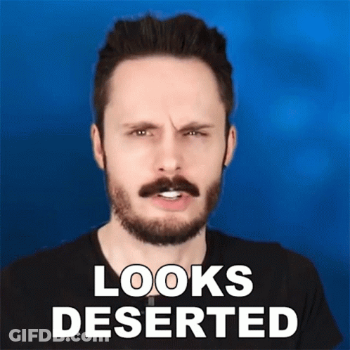 A Man With A Beard And Mustache Is Making A Funny Face With The Words Looks Deserted Below Him GIF