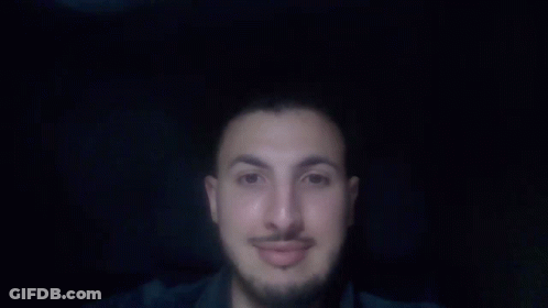 A Man With A Beard And Mustache Is Pointing Up With His Finger GIF