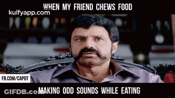 A Man With A Beard And Mustache Is Sitting In A Chair . GIF
