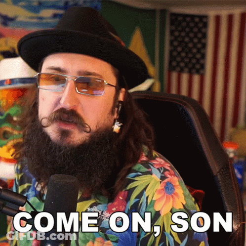 A Man With A Beard And Mustache Is Sitting In Front Of A Microphone And Says Come On Son GIF