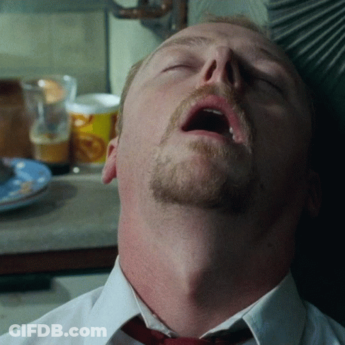 A Man With A Beard And Mustache Is Sleeping With His Mouth Open GIF