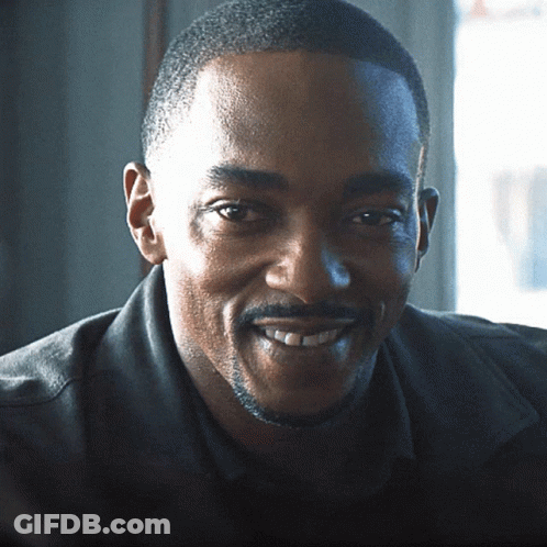 A Man With A Beard And Mustache Is Smiling GIF