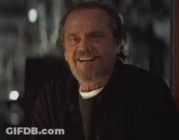 A Man With A Beard And Mustache Is Smiling And Looking At The Camera . GIF