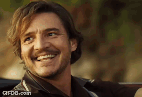 A Man With A Beard And Mustache Is Smiling And Looking At The Camera . GIF