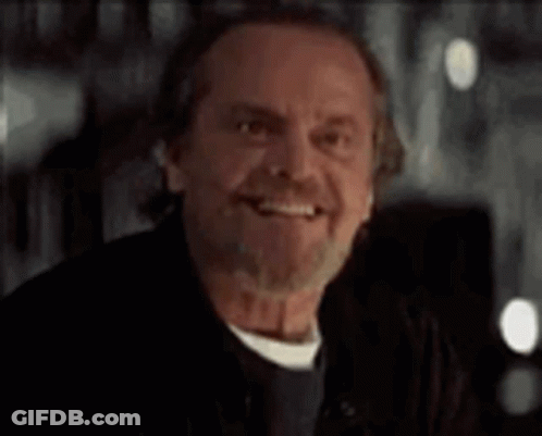A Man With A Beard And Mustache Is Smiling And Looking At The Camera . GIF