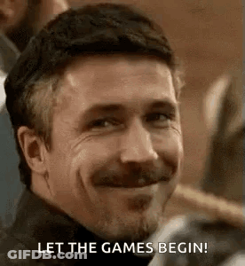 A Man With A Beard And Mustache Is Smiling And Saying `` Let The Games Begin ! '' GIF
