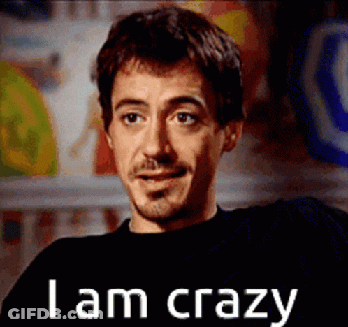 A Man With A Beard And Mustache Is Smiling And Says I Am Crazy GIF