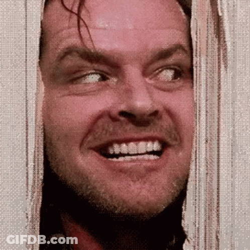 A Man With A Beard And Mustache Is Smiling While Looking Through A Window . GIF