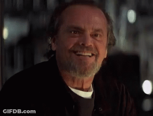 A Man With A Beard And Mustache Is Smiling . GIF