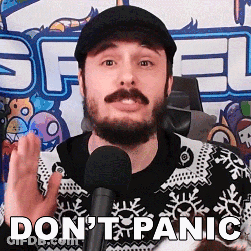 A Man With A Beard And Mustache Is Talking Into A Microphone With The Words " Do N't Panic " Above Him GIF