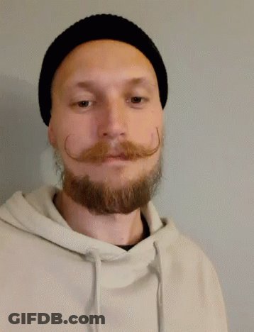 A Man With A Beard And Mustache Is Wearing A Black Hat And Giving A Thumbs Up GIF