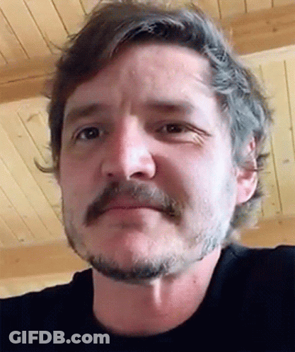 A Man With A Beard And Mustache Is Wearing A Black Shirt GIF