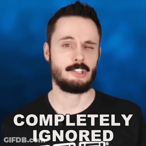 A Man With A Beard And Mustache Is Wearing A Black Shirt That Says Completely Ignored GIF