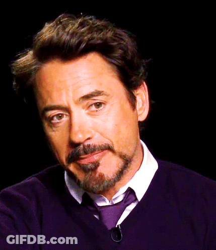 A Man With A Beard And Mustache Is Wearing A Purple Sweater And Tie GIF