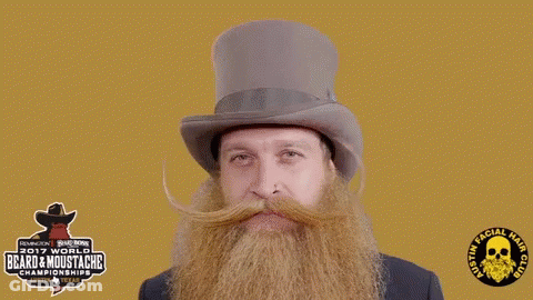 A Man With A Beard And Mustache Is Wearing A Top Hat Sponsored By The 2017 World Beard & Moustache Championship GIF
