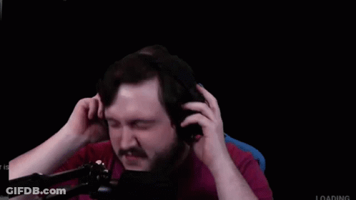 A Man With A Beard And Mustache Is Wearing Headphones In Front Of A Microphone . GIF