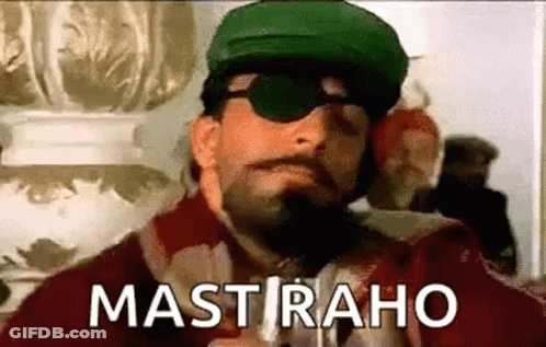 A Man With A Beard And Mustache Wearing Sunglasses And A Green Hat Is Smoking A Cigarette . GIF