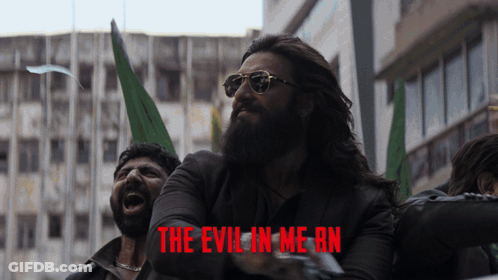 A Man With A Beard And Sunglasses Is Screaming In Front Of A Poster That Says The Evil In Me An GIF