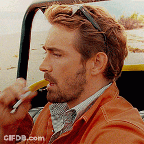 A Man With A Beard And Sunglasses Is Smoking A Cigarette GIF