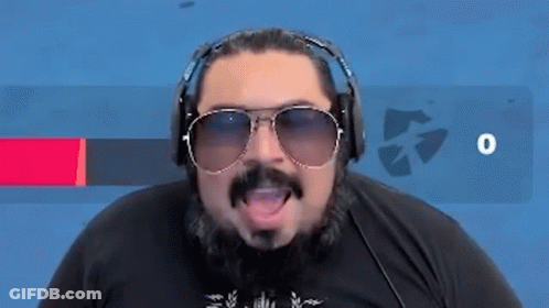 A Man With A Beard And Sunglasses Is Wearing Headphones And Saying Eso . GIF
