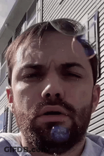 A Man With A Beard And Sunglasses On His Head Is Making A Funny Face GIF