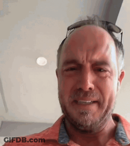 A Man With A Beard And Sunglasses On His Head Is Making A Funny Face . GIF