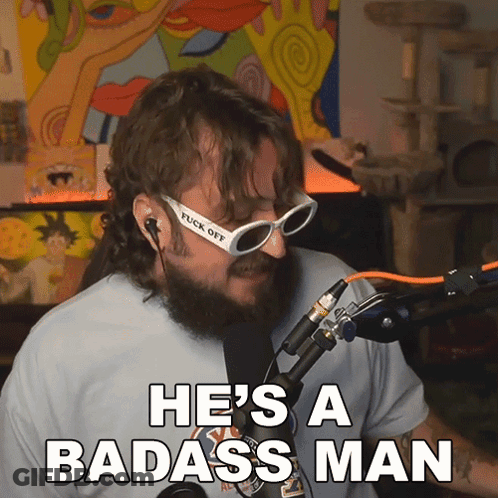 A Man With A Beard And Sunglasses Says He 'S A Badass Man In Front Of A Microphone GIF