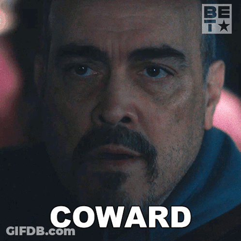 A Man With A Beard And The Word Coward Written On His Face GIF