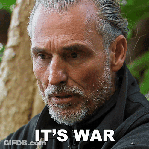 A Man With A Beard And The Words " It 'S War " On His Face GIF