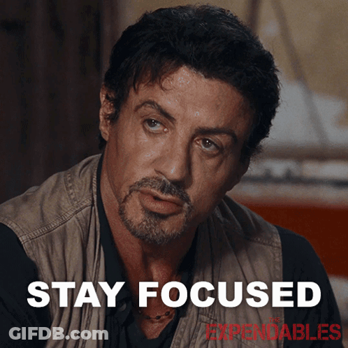 A Man With A Beard And The Words Stay Focused Behind Him GIF