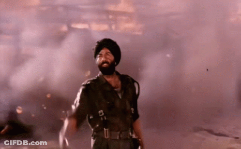 A Man With A Beard And Turban Is Standing In A Smokey Room GIF