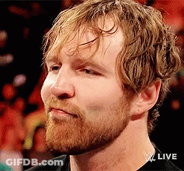 A Man With A Beard And Wet Hair Is Wearing A Black Shirt And Looking At The Camera . GIF