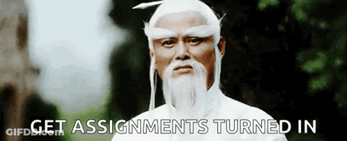A Man With A Beard And White Hair Is Standing In Front Of Trees And Says `` Get Assignments Turned In '' . GIF