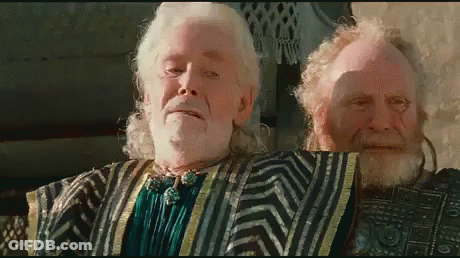 A Man With A Beard And White Hair Is Standing Next To Another Man With A Beard GIF