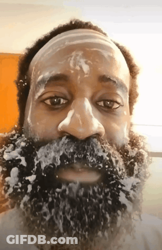 A Man With A Beard Covered In Foam Looks At The Camera GIF