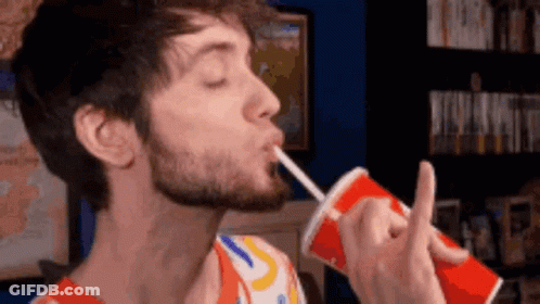 A Man With A Beard Drinking From A Red Cup With A Straw GIF