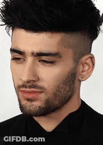 A Man With A Beard Has A Nose Ring On His Left Ear GIF